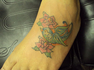 bird and flower ankle tattoo