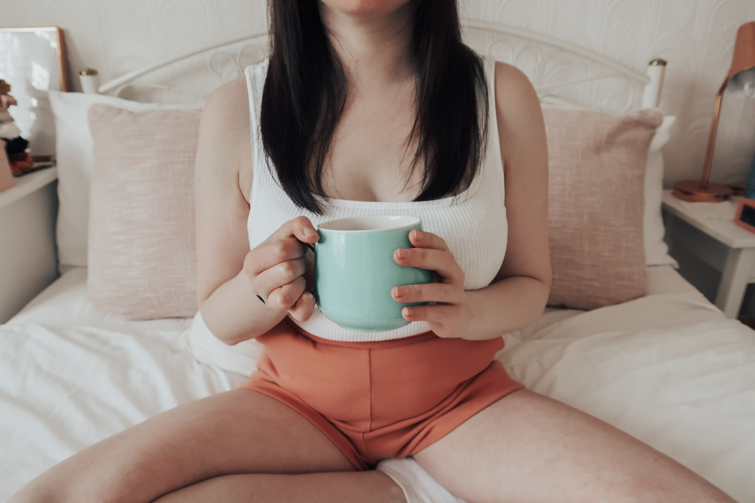 A woman holding a turquoise mug
