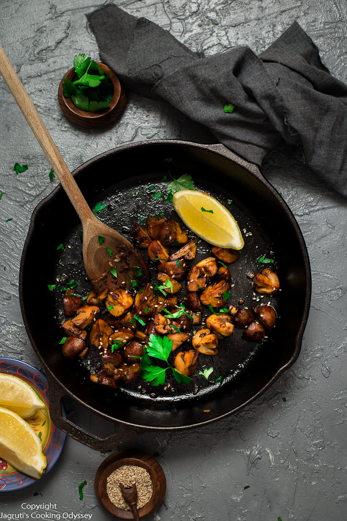 Soy and garlic mushroom stir fry served in a round cast iron skillet