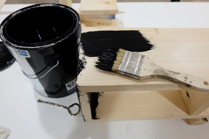 painting cubbie shelf unit with black paint