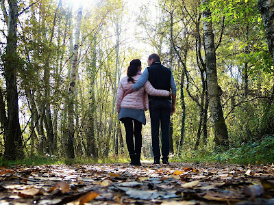 two people in a wooded area