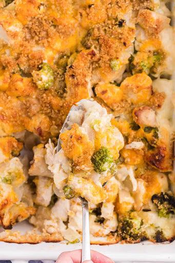 a spoon scooping casserole from a baking dish.