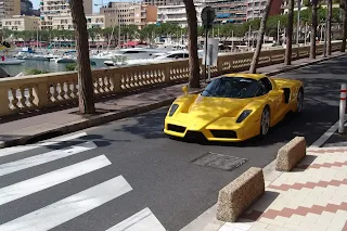 "Ferrari Enzo in Monaco, highlighting its stunning design and luxury status against a backdrop of upscale streets."
