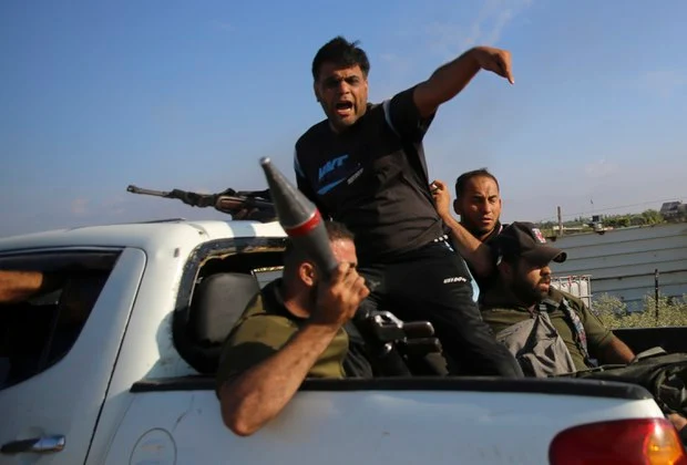 Cover Image Attribute: On October 7, 2023, Palestinian militants were seen transporting what seems to be an F-7 rocket-propelled grenade launcher of North Korean origin, marked with a distinctive red band, as they headed back to the Gaza Strip. / Source: Ali Mahmud/AP