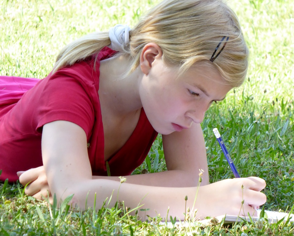 NAMC montessori today chapter 7 freedom responsibility. Girl writes in her student work journal