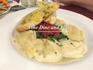 Goat cheese stuffed ravioli with a garlic broth and broccolini 