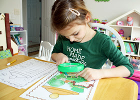 Tessa used a magnifying glass to search for hidden St. Patrick's Day words. She carefully copied them onto a record sheet as her handwriting lesson for the day. She really got a kick out this. Never have I seen her so eager to complete handwriting.