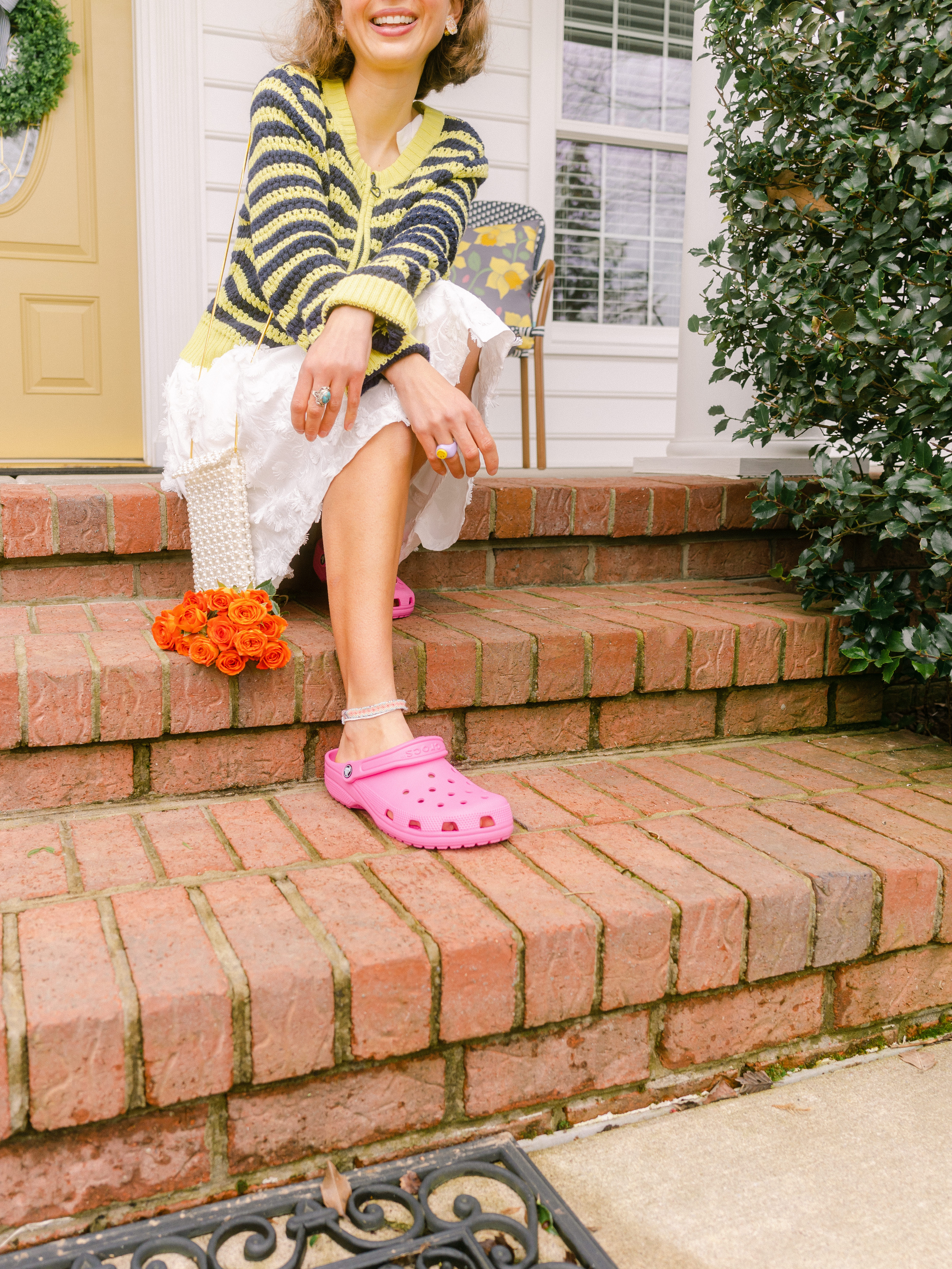 Woman wearing fuchsia crocs