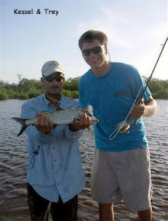 Photo of Kessel, holding a bonefish, and Trey