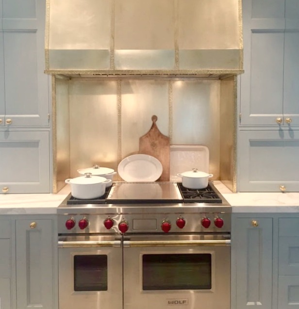 Brass range hood over Wolf range in kitchen in 2017 Southeastern Designer Showhouse in Atlanta