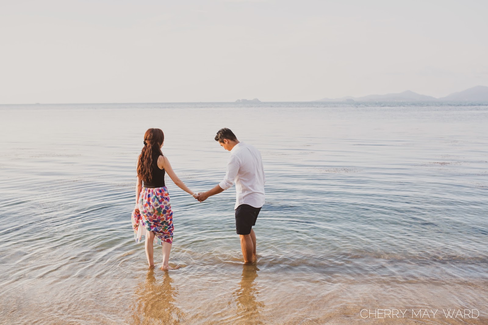 Couple's engagement session on the beach at Koh Samui, holding hands in the water enjoying the sunset, beautiful beach setting for engagement photos on Koh Samui