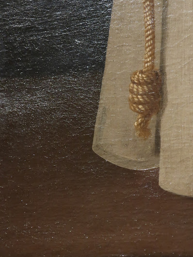 Photo; detail of a painting. Brown background; white drapery in the upper-right-hand quadrant; a gold cord with a tassel at the end.