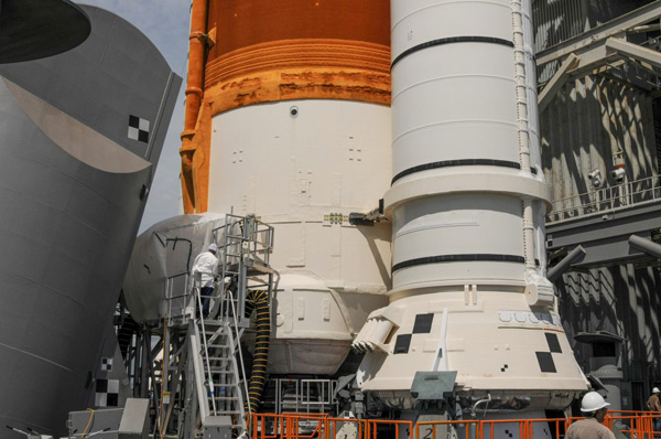 After setting up a temporary enclosure near the Space Launch System's engine section, technicians inspect the quick disconnect plate connecting the Tail Service Mast Umbilical to the mega-Moon rocket...on September 8, 2022.