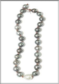 A string of black Tahitian Pearls offset with one South Sea pearl