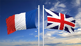 Pic of French and British flags flying at top of flagpoles in opposite directions