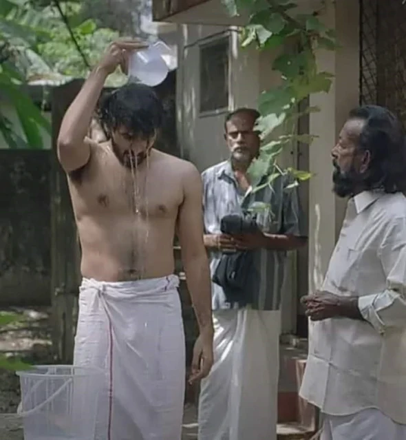 Guy takes Bath with White Veshti