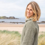 image of author with a beach behind her