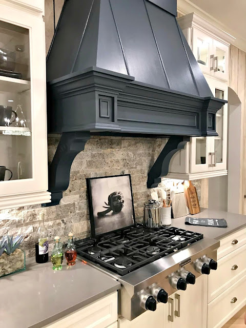 Dark blue vent hood white kitchen