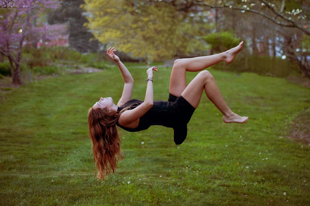 woman floating on a green field