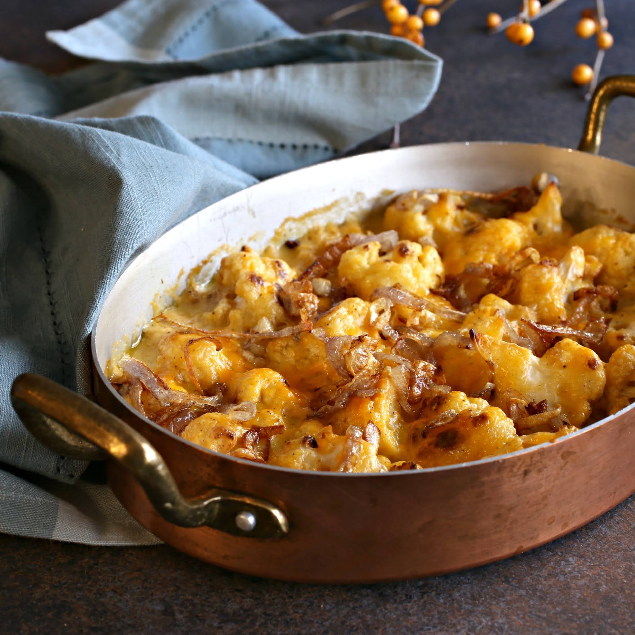 Recipe for a cheddar cheese cauliflower gratin topped with fried shallots.