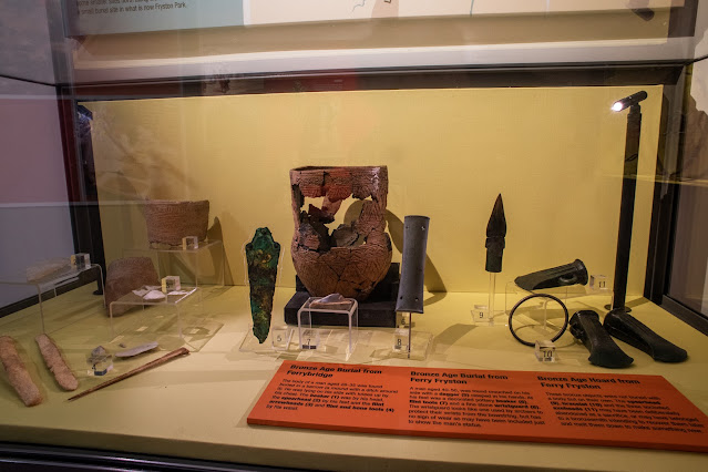 Display case containing bronze age burial finds, some ceramic and some metal