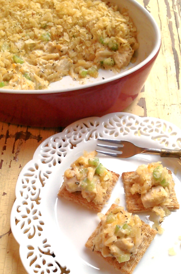 Hot Chicken Salad! A retro appetizer recipe made with chicken, almonds, cheese and celery topped with crushed potato chips served hot with crackers or served as a casserole.