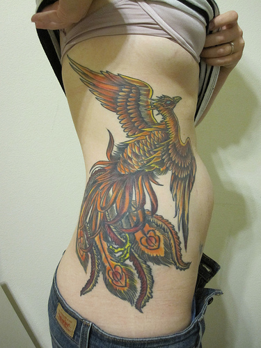 Phoenix tattoo on woman body a part waist with colour full constitute best 