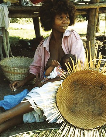 Agta woman with child and baskets