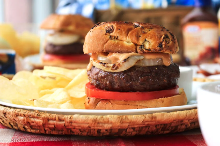 Bacon and Cheese Stuffed BBQ Burgers will be the highlight of your next barbecue!  These juicy burgers stuffed with American cheese and bacon are topped with grilled onions and a zesty barbecue mayo burger sauce.  #ad #burgers #grill @Heinz @Kraft