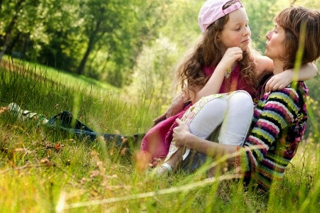 NAMC montessori positive time outs girl and mother sitting in grass