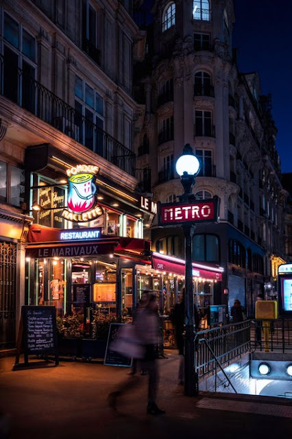 nightime shot of Metro Richelieu Drouot exit, on boulevard des Italiens