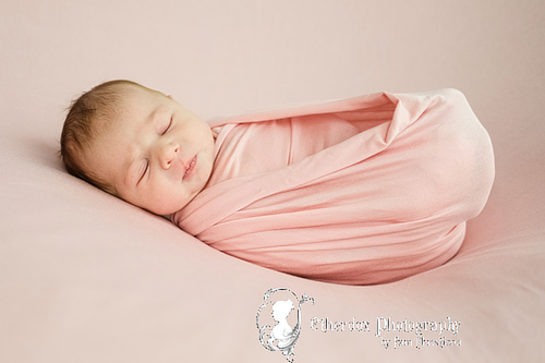Professional portrait of a newborn baby using a round backdrop stand