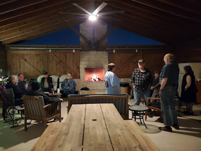 group gathering around a fireplace in a pavilion