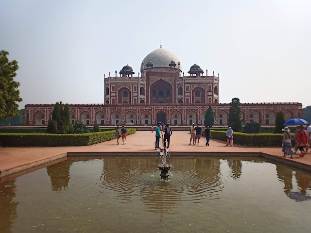 View of Humayun's tomb building from behind water fountain