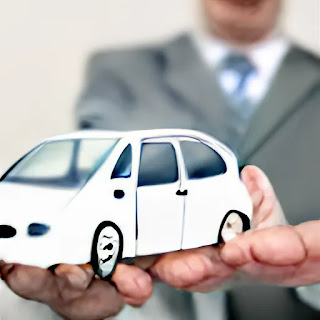 Car Insurance man shows a man holding a toy car wearing a black suit with light skin showing as well