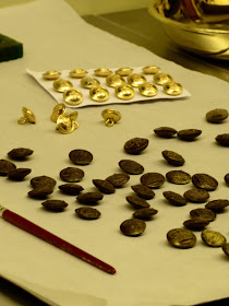 Making chocolate buttons in the mould of uniform buttons   in the kitchen display in a Royal Welcome  2015 exhibition at Buckingham Palace  Photo © Andrew Knowles