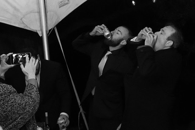 Groom and Groomsman wolfbiting some bud lights Magnolia Farm Asheville Wedding Photography captured by Houghton Photography