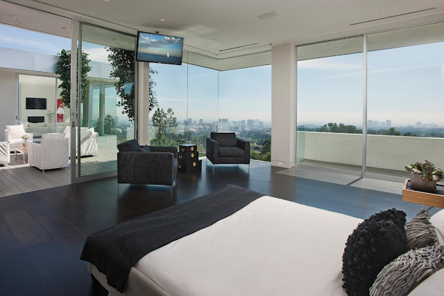 Bedroom with glass walls and terrace exit 