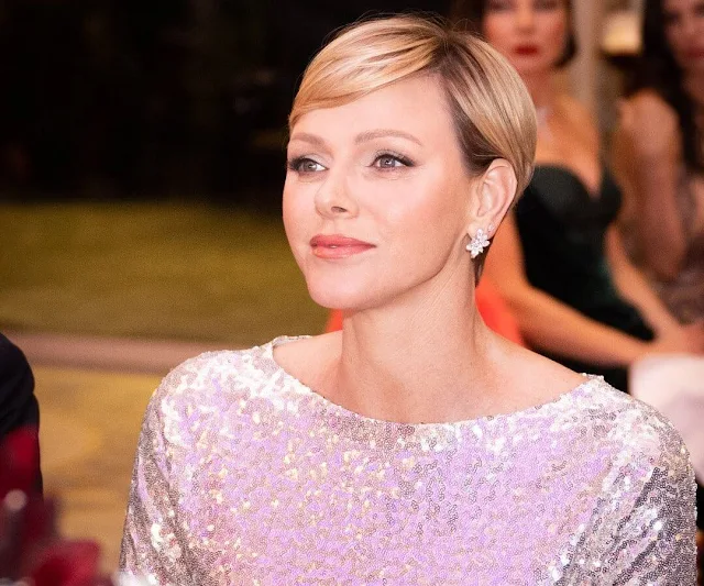 Princess Charlene wore a metallic embroidery sequined gown by Akris. Diamond flower earrings by Dior