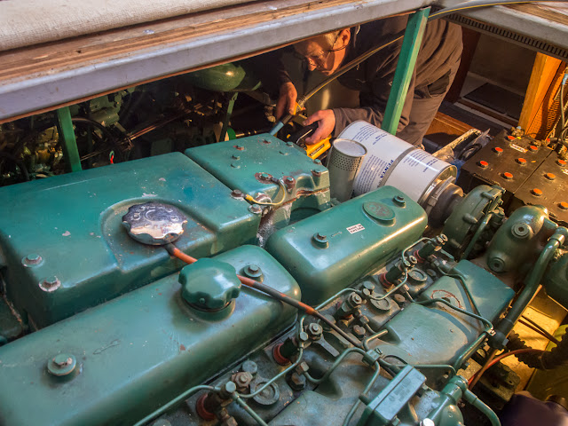 Photo of Phil pouring water into the engine room bilges