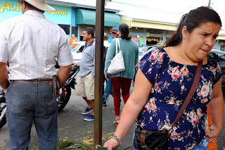 People on a busy street corner in Puriscal.