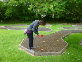 Minigolfer Emily Gottfried at the Crazy Golf course at the Thorne Park Golf Centre in Salcombe Regis, near Sidmouth, Devon