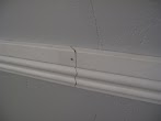 Chair Rail Corner Cuts / Chair Rail Corner (Bronze) - Measure and mark the place where you will cut, and position the rail with its plane face touching the back of the miter box.