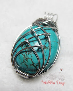 a caged turquoise pendant