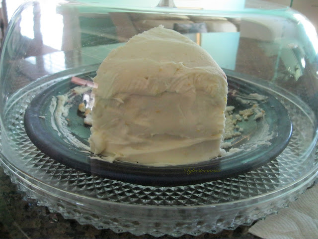 piece of lemon cake inside acrylic cake plate with dome