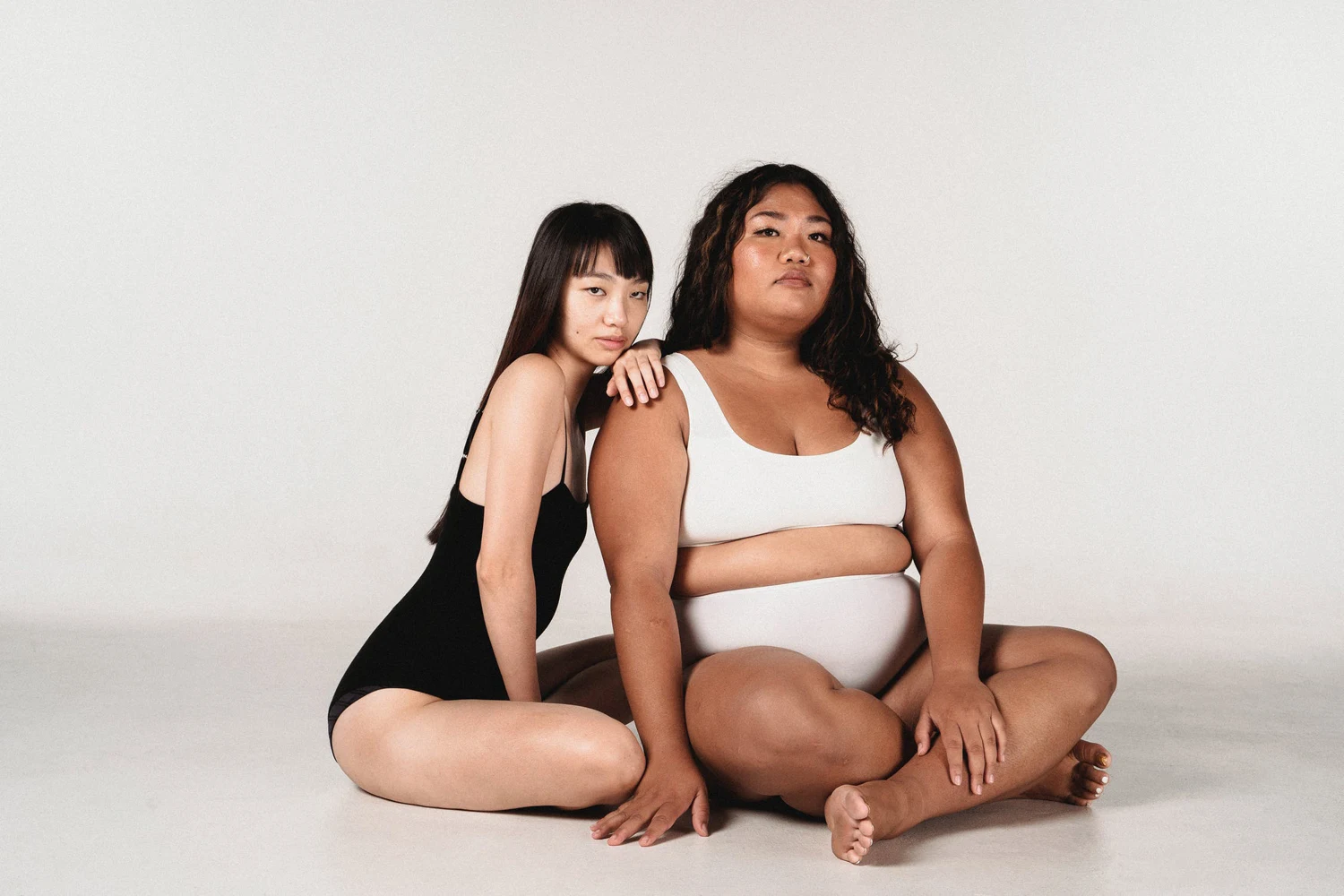 two Charming women sitting in studio together