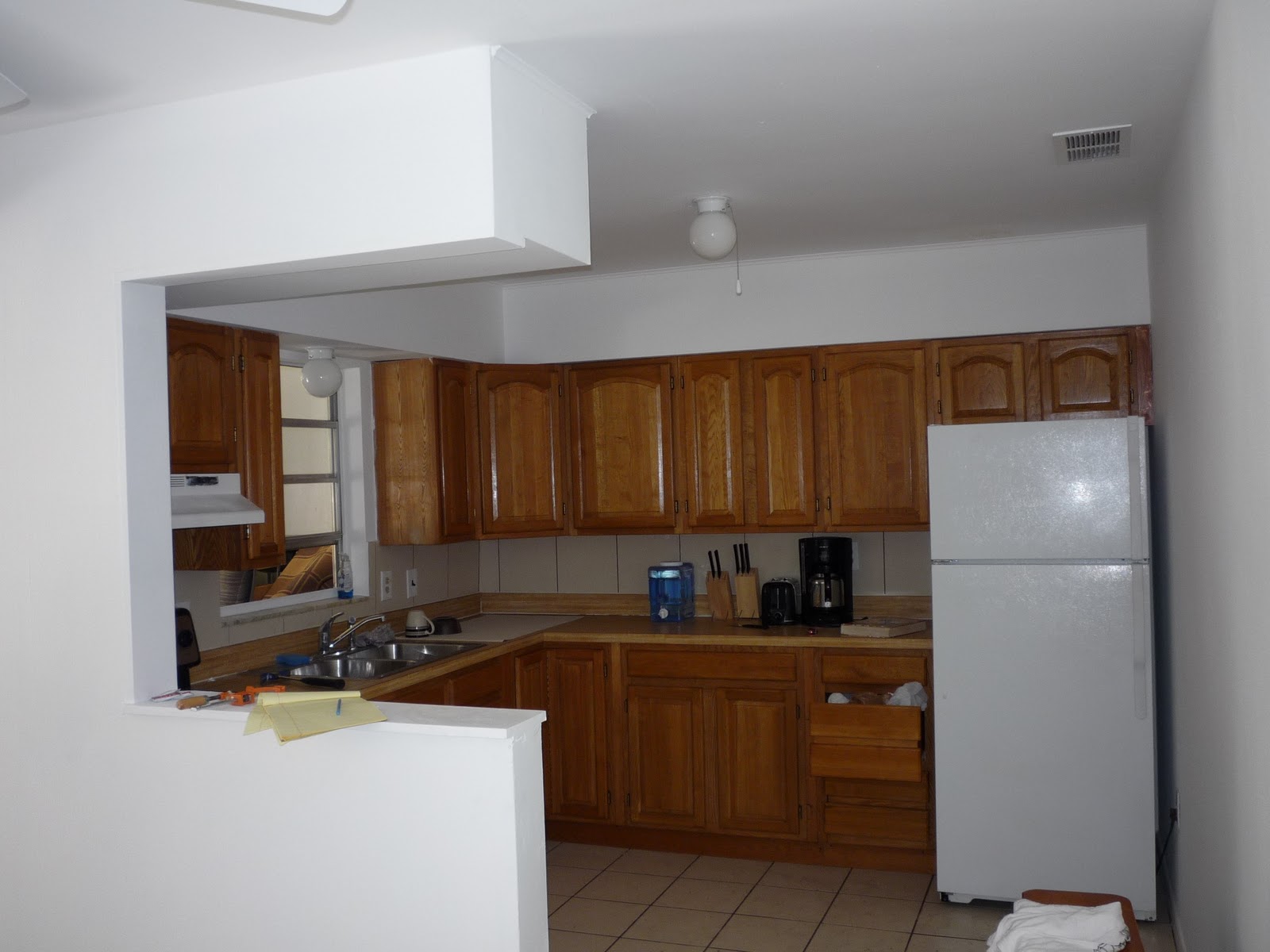 Kitchen and dining area in progress; painted bright white, cabinets 