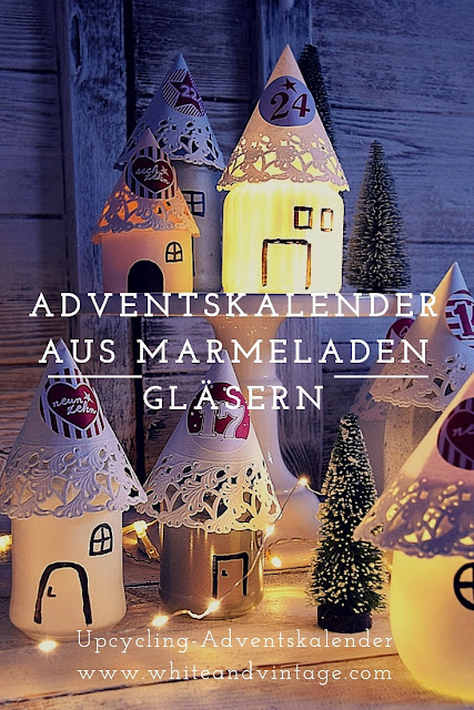 Leuchtende Adventshäuser als Adventskalender