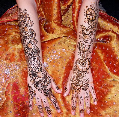 Intricate patterns of mehndi are typically applied to brides before wedding 