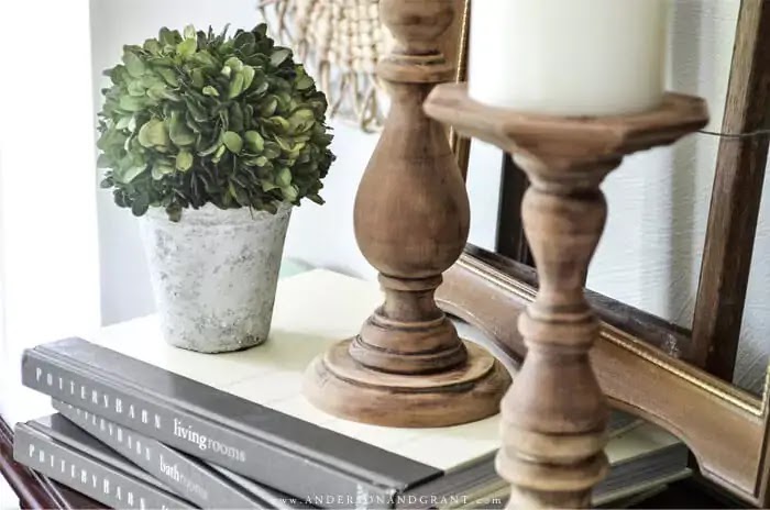 Rustic wood candlesticks and boxwood plant
